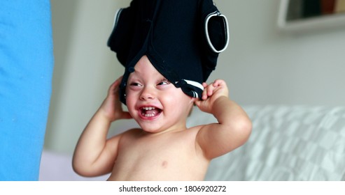 Parent Removing Baby Shirt, Clothing Stuck In Toddler Head, Mother Changing Child Clothing. Fun And Laughter