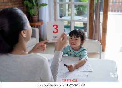 Parent Showing Number On A Flash Card During Studying At Home