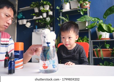 Parent Sitting Homeschooling With Little Kid, Father And Son Having Fun Making Easy Science Experiment 