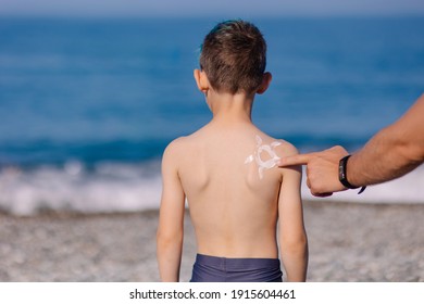 A Parent Smears A Child With Sunscreen. Sun Protection. Preventing Sunburn. Baby Cream. Caring For The Health Of The Skin. A Tan