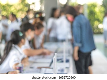Parent Teacher Appointment PTA At School Concept. Blur Abstract Background Students Register At Registration Desk In Front Of Education Conference. 