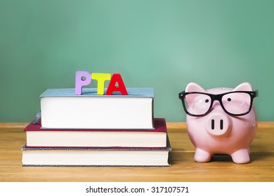 Parent Teacher Association Theme With Pink Piggy Bank With Chalkboard In The Background As Concept Image Of The Costs Of Education