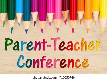 Parent Teacher Conference text with colorful pencil crayons on a wood desk