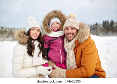 Parenthood, Fashion, Season And People Concept - Happy Family With Child In Winter Clothes Outdoors