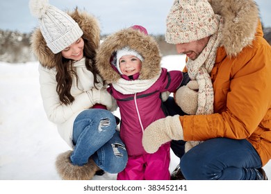 Parenthood, Fashion, Season And People Concept - Happy Family With Child In Winter Clothes Outdoors