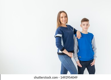 Parenting, Family And Single Parent Concept - A Happy Mother And Teen Son Laughing And Embracing On White Background With Copy Space