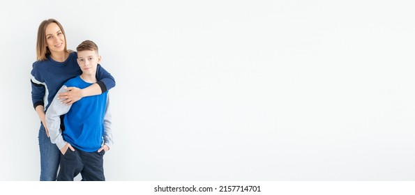 Parenting, Family And Single Parent Concept - A Happy Mother And Teen Son Laughing And Embracing On White Background Banner With Copy Space