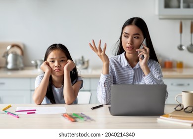 Parenting Problems During Lockdown. Busy Working Mother Having No Time For Her Daughter, Answering Business Phone Call, Sitting In Kitchen With Child. Teen Girl Feeling Neglected By Her Mom