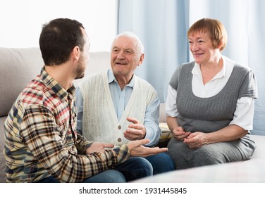 Parents and adult son enjoying quiet evening together at home