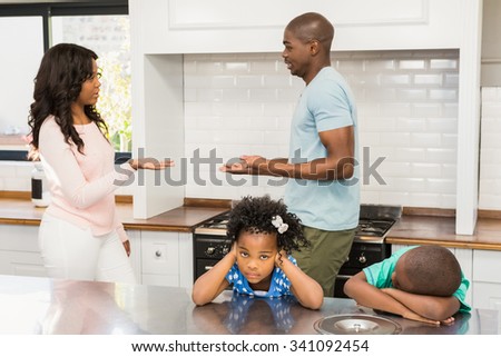 Parents arguing in front of children in the kitchen