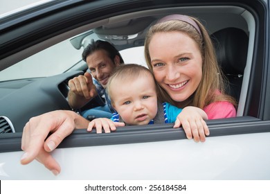 Parents And Baby On A Drive In Their Car