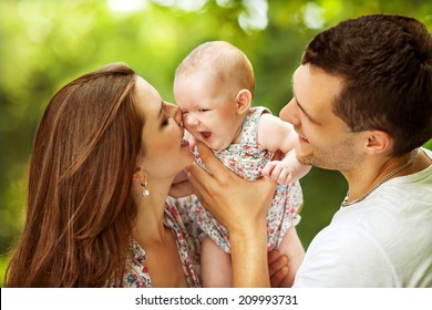 Parents With Baby In Park