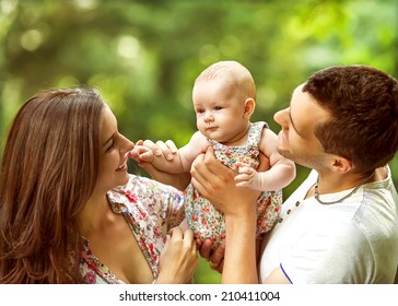 Parents With Baby In Park