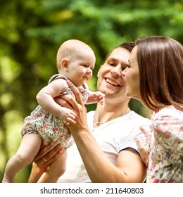 Parents With Baby In Park