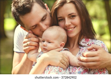 Parents With Baby In Park 