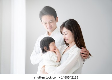 
Parents and baby standing by the window