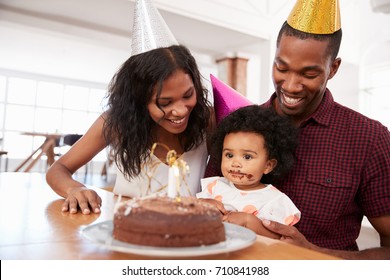 Parents Celebrating Birthday With Young Daughter At Home