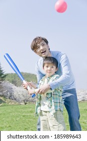 Parents And Child Playing Baseball