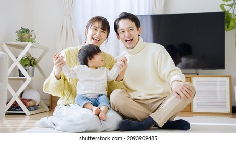 Parents And Child In Winter Clothing