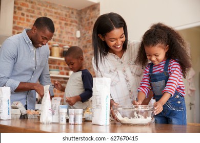 Parents And Children Baking Cakes In Kitchen Together - Powered by Shutterstock