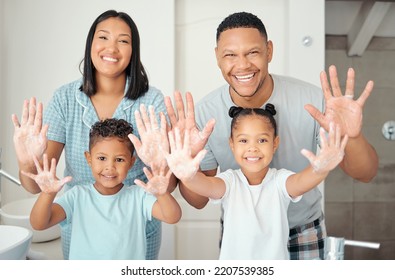 Parents, Children And Cleaning Hands As A Happy Family In A Bathroom Together At Home With A Proud Mother And Father. Smile, Dad And Healthy Mom Enjoys A Wellness And Cleanliness Lifestyle With Kids