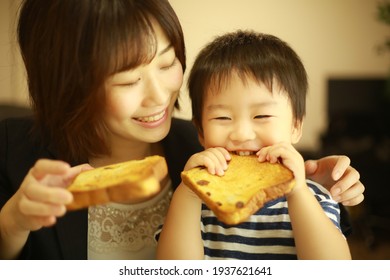 Parents And Children Eating Bread 