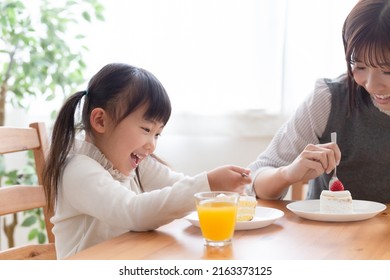 Parents and children eating cake - Powered by Shutterstock