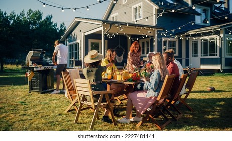 Parents, Children and Friends Gathered at a Barbecue Dinner Table Outside a Beautiful Home. Old and Young People Have Fun, Eat and Drink. Garden Party Celebration in a Backyard. - Shutterstock ID 2227481141