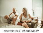 Parents, children and joy with a family on the sofa in the living room of their home together for bonding. Mother, father and kids in the house with a cute baby and playful boy laughing in the lounge