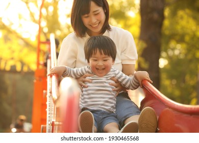 Parents And Children Playing On The Slide 