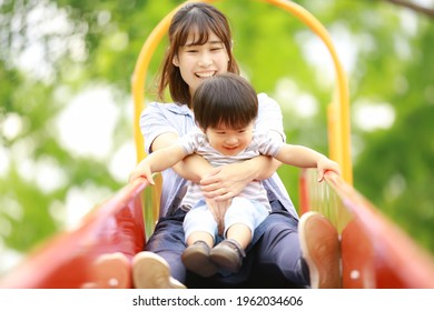 Parents And Children Playing On The Slide 
