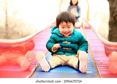 Parents And Children Playing On The Slide 