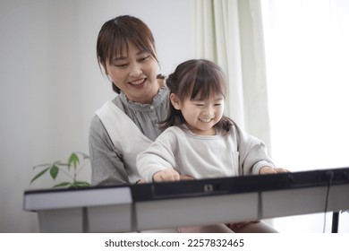 Parents and children practicing playing the piano - Powered by Shutterstock