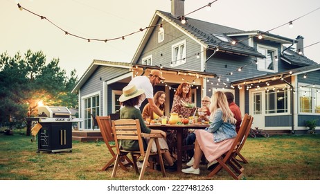 Parents, Children, Relatives and Friends Having an Open Air Barbecue Dinner in Their Backyard. Old and Young People Talk, Chat, Have Fun, Eat and Drink. Garden Party Celebration in a Backyard. - Powered by Shutterstock