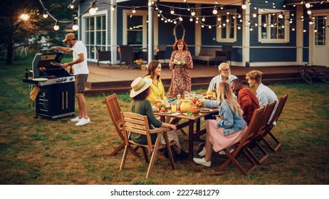 Parents, Children, Relatives and Friends Having an Open Air Barbecue Dinner in Their Backyard. Old and Young People Talk, Chat, Have Fun, Eat and Drink. Garden Party Celebration in a Backyard. - Powered by Shutterstock