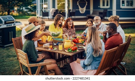 Parents, Children, Relatives and Friends Having an Open Air Vegetarian Dinner in Their Backyard. Old and Young People Talk, Chat, Have Fun, Eat and Drink. Garden Party Celebration in a Backyard. - Powered by Shutterstock