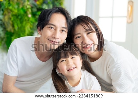 Parents and children taking a commemorative photo in a photo studio. Asian family.