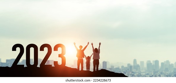 Parents and children who are happy to see the sunrise. 2023 New Year concept. Wide angle visual for banners or advertisements. - Shutterstock ID 2234228673