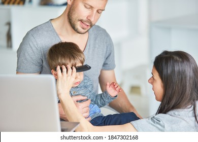 Parents Cut Their Own Hair With The Help Of An Online Tutorial On Their Laptop Computer