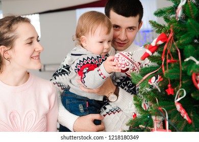 Parents With Daughter Dress Up Christmas Tree