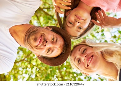 Parents And Daughter As A Small Family On Summer Vacation In Nature