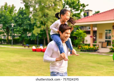 Parents and daughters go for a walk in the park. - Powered by Shutterstock