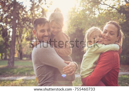 Parents give a hug daughters. Happy smiling family. 