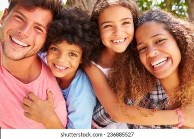 Parents Giving Children Piggyback Ride Outdoors - Shutterstock ID 236885527