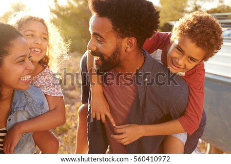 Parents giving their kids piggybacks, waist up, close up