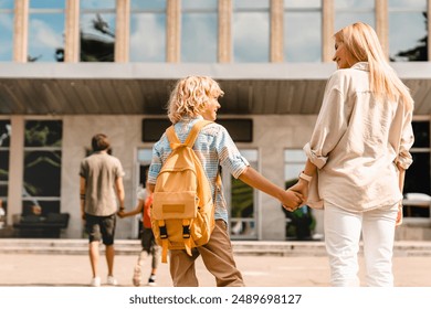 Parents going back to school with their children after summer holidays lockdown. The start of new academic semester year. Preparation for lessons classes - Powered by Shutterstock