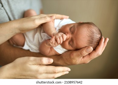 Parents hands holding newborn baby head. Motherhood, fatherhood or parenthood and fathers day concept. Modern parenthood. Comfort and safety sleep. Human insurance. Family miracle. - Shutterstock ID 2108957642