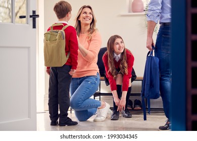 Parents Helping Children In Uniform To Get Ready To Leave Home For School - Powered by Shutterstock