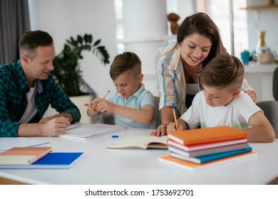 Parents helping the kids with their homework. Litlle boys learning at home. - Shutterstock ID 1753692701