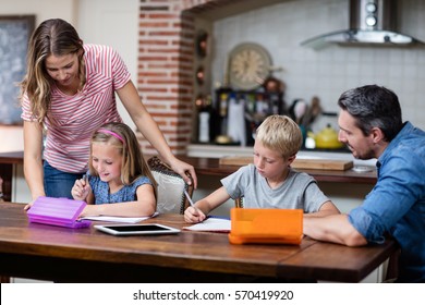 Parents helping the kids with their homework